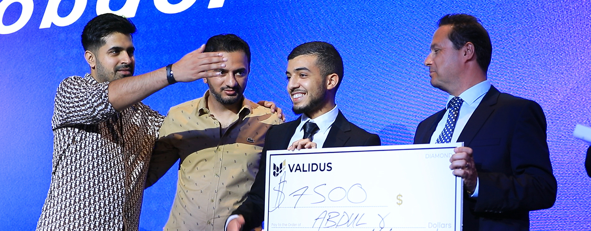 Validus event presenting oversized cheque on stage